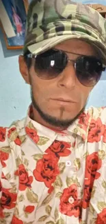 Portrait with camo hat and floral shirt, inside a room.