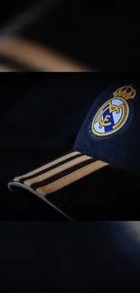 Real Madrid cap with emblem on dark background.