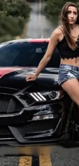 Model poses by a black and red sports car on a street.