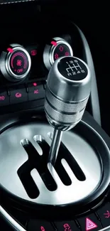 Car gear shift with metallic and red accents, sleek design.