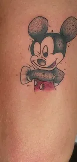 Cartoon tattoo design on arm with classic colors.