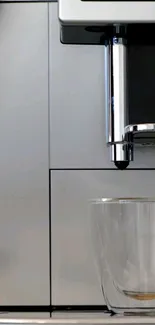 A sleek, modern coffee maker with glass cup.