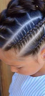 Stylish cornrow braids on girl's hair, close-up view.