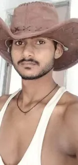 Man wearing a cowboy hat posing for a rustic mobile wallpaper.