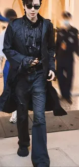 Person in stylish dark outfit walking with confidence.