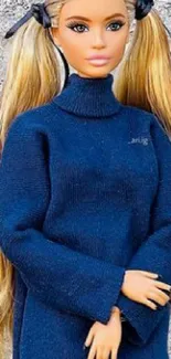 Fashion doll in a dark blue sweater with blonde hair and pigtails.