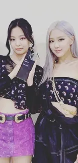 Fashion duo in stylish black and purple outfits.