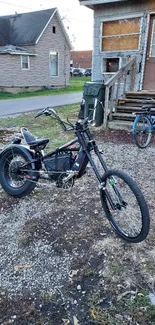 Stylish black electric bike parked by vintage house.