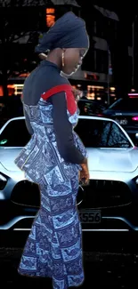 Stylish figure in patterned outfit with city backdrop at night.