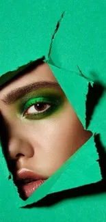 Vibrant green eye through torn paper, artistic mobile wallpaper.