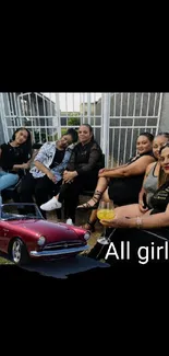 Group of women with a red classic car in outdoor setting.