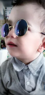 Adorable baby with sunglasses in a chic outfit.