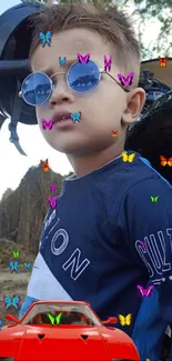 Stylish kid with sunglasses surrounded by colorful butterflies and a red car.