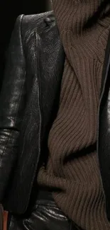 Fashionable leather jacket with brown turtleneck sweater.