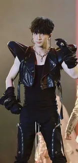 Performer in stylish black leather outfit at a concert.