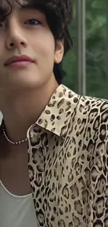 Stylish man in leopard print shirt against nature.