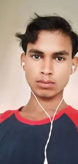 Close-up portrait of a young person wearing earbuds, set as a mobile wallpaper.