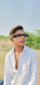 Young man in sunglasses with nature background.