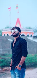 Man in sunglasses with beach and temple background.