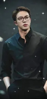 A stylish man in a black outfit standing against a dark background.