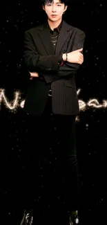 Stylish man in black suit with cosmic background wallpaper.