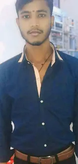 Man wearing a blue button-up shirt, looking stylish and trendy.