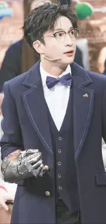 Stylish man in blue suit with bowtie and glasses.