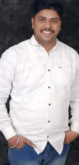 Stylish man in white shirt against dark textured background.