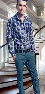 Fashionable man on a spiral staircase with chandelier lighting.