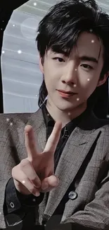 Mobile wallpaper of a stylish man in a suit with a peace sign.