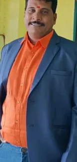 Vibrant wallpaper of stylish man in orange and blue outfit.