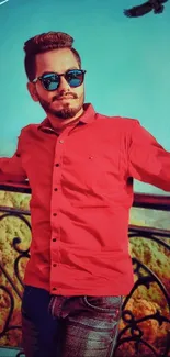 Stylish man in sunglasses leaning on a balcony with a bird above.