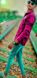 Man wearing sunglasses on railway track with a stylish outfit.