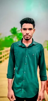 A stylish man in a green shirt on a wooden bridge.