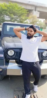 Confident man poses in front of a stylish SUV under an overpass.