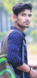 Stylish young man with backpack in nature.