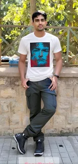 Young man in graphic t-shirt with nature background.