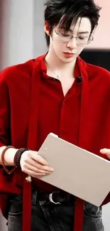 Stylish man in red shirt with book and glasses.