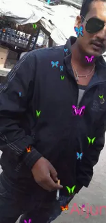 Man in black jacket and sunglasses outdoors.