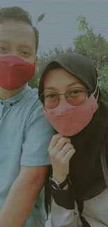 Couple wearing stylish face masks in an outdoor setting.