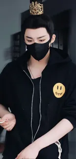 A masked individual with a crown in a stylish black hoodie.