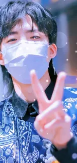 Masked person with peace sign in a stylish, blue-themed portrait.