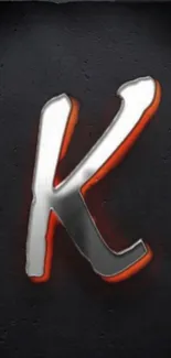 3D metallic letter 'K' with orange accents on dark background wallpaper.