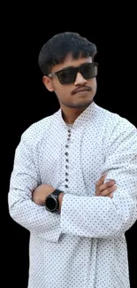 Stylish person in polka-dot shirt on black background wallpaper.