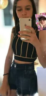 Mirror selfie with phone and stylish outfit.