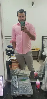 Mirror selfie with a pink shirt for a stylish wallpaper.