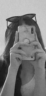 Trendy black and white mirror selfie for chic phone wallpaper.