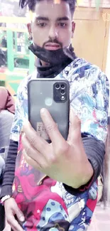 Mirror selfie wallpaper with stylish, colorful attire and a smartphone.