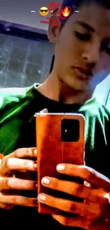 Stylish mirror selfie with green shirt and phone in hand.