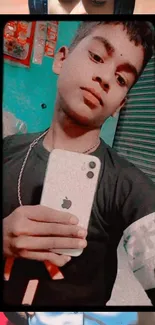 Stylish youth taking a selfie with iPhone in vibrant mobile wallpaper.